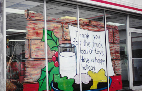 Christmas painting on a car dealership window.