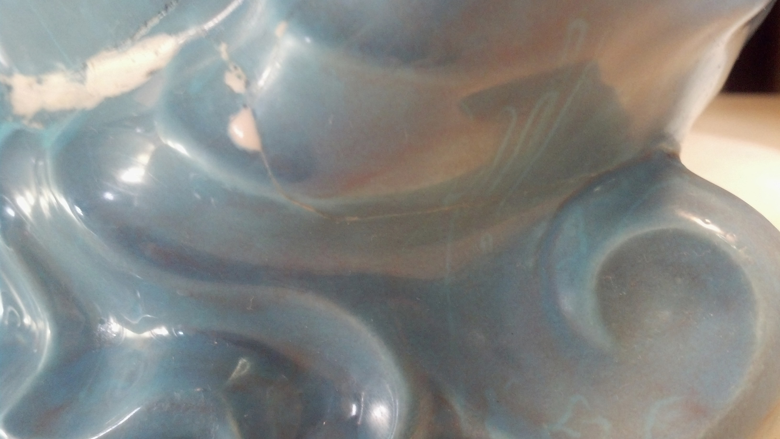 Damaged milk pitcher showing that it has been put back together.